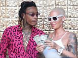*PREMIUM-EXCLUSIVE* Los Angeles, CA - *PREMIUM EXCLUSIVE* **MUST CALL FOR PRICING** **USA AND CANADA STRICTLY NO TV, NO WEB* Los Angeles, CA - Amber Rose and Wiz Khalifa celebrated their divorce Monday night at a strip club, and now we know why ... each did more than okay in the settlement.\n\nAmber and Wiz filed their settlement agreement with the court, and the headline ... she gets a cool million under the prenup. Wiz has already paid $356k, so he still owes her $644k.\n\nBut Amber gets more ... $14,800 a month in child support for their 3-year-old son, Sebastian, with whom they share legal and physical custody.\n\nAs for Wiz ... he gets the Pennsylvania home and 10 cars, including a '69 Chevelle, a '68 Camaro, a '62 and a '64 Impala and a Porsche, of course, of course.\n\nBiggest thing ... they're both good with the way the divorce ended, which is ultimately good for the kid.\n\n **MANDATORY CREDIT: TMZ/AKM-GSI** **USA AND CANADA STRICTLY NO TV, NO WEB**\n\nAKM-GSI       June 7, 2