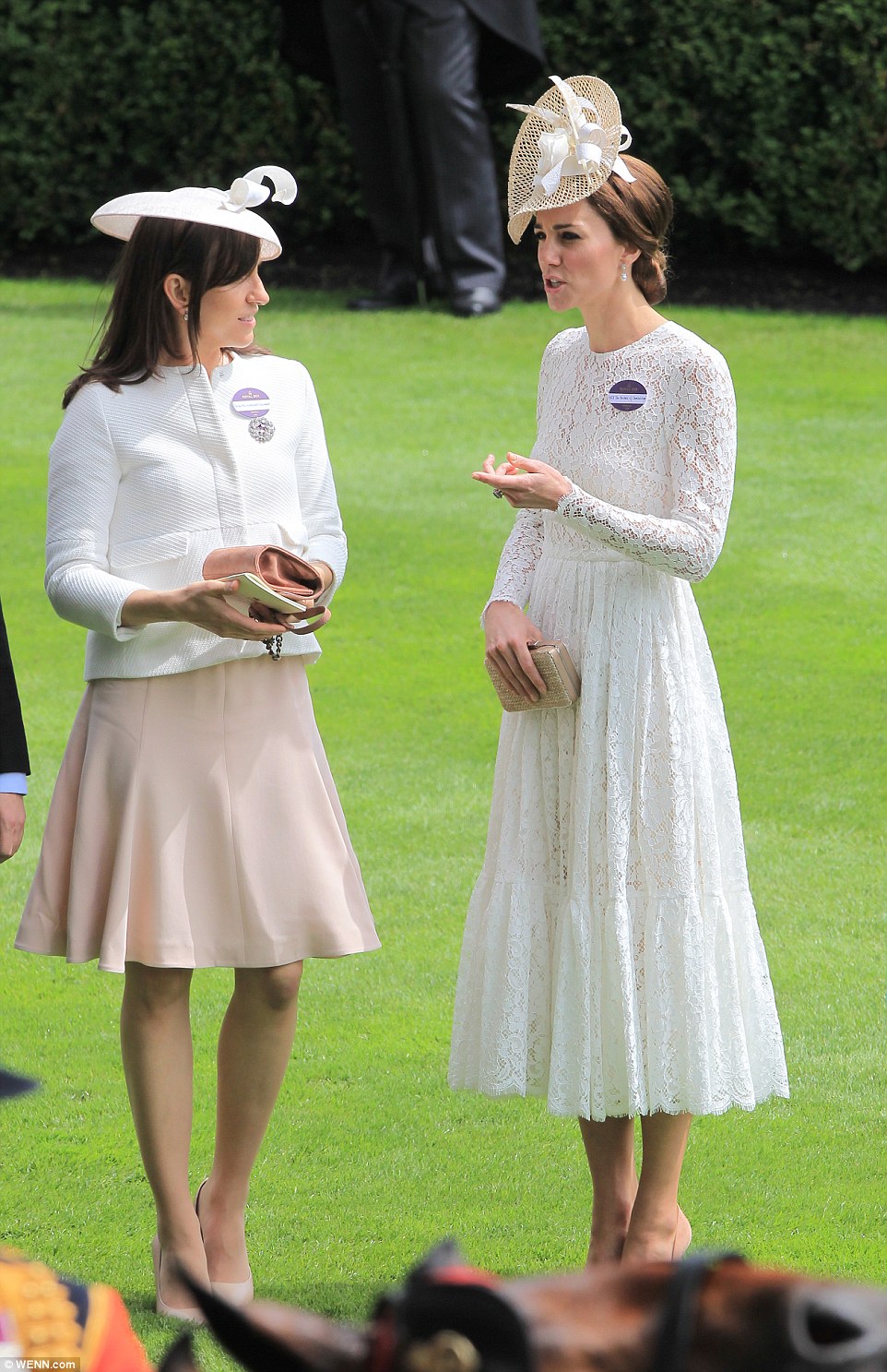 The Duchess of Cambridge chats to a fellow racegoer 