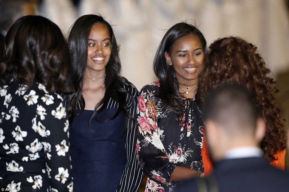 King Mohammed VI's wife Princess Lalla Selma (rear right) met Michelle Obama (left) and daughters Malia and Sasha at the airport