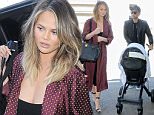 Los Angeles, CA - Chrissy Teigen arrives for a Friday flight out of Los Angeles at LAX with her daughter Luna and John Legend close behind. The model wore another cleavage baring top under a silk robe as she pushed her daughter in her stroller through the terminal for their flight.\nAKM-GSI   July  8, 2016\nTo License These Photos, Please Contact :\nMaria Buda\n(917) 242-1505\nmbuda@akmgsi.com\nsales@akmgsi.com\nor \nMark Satter\n(317) 691-9592\nmsatter@akmgsi.com\nsales@akmgsi.com\nwww.akmgsi.com