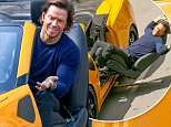 Detroit, MI - Mark Wahlberg gets back to work with director Michael Bay on the set of 'Transformers: The Last Knight' in Detroit, Michigan. Mark takes a spin in Bumblebee on the streets of Detroit during a scene. Between takes the star promotes his Wahlbergers burger chain with a baseball cap and T-shirt while greeting some fans.\nAKM-GSI   July  23, 2016\nTo License These Photos, Please Contact :\nMaria Buda\n(917) 242-1505\nmbuda@akmgsi.com\nsales@akmgsi.com\nor \nMark Satter\n(317) 691-9592\nmsatter@akmgsi.com\nsales@akmgsi.com\nwww.akmgsi.com