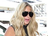 Tuesday, July 26, 2016 - Kim Zolciak arrives at LAX holding onto a plastic Solo cup and showing extremely plump lips after SnapChatting a trip to her plastic surgeon yesterday. The reality TV star lookis sexy in a sheer black bodycon top, leggings and heels as she leaves L.A. with NFL hubby Kroy Biermann and children Brielle and Ariana and Kroy Biermann Jr. Gio/X17online.com