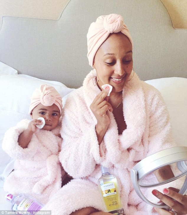 Beauty cuties: Tamera Mowry-Housley made her mourning routine into a sweet mother daughter moment with baby Ariah as she promoted Dickinson's Witch Hazel on Friday