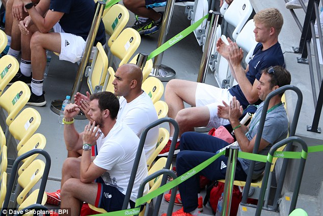 Leon Smith (front row, left) and Kyle Edmund (back row, right) watch Murray in round two 
