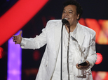 FILE- In this April 28, 2016, file photo, singer Juan Gabriel receives the Star Award at the Latin Billboard Awards, in Coral Gables, Fla. Representatives of Juan Gabriel have reported Sunday, Aug. 28, 2016, that he has died. Gabriel was Mexico's leading singer-songwriter and top-selling artist with sales of more than 100 million albums. The statement says he died Sunday, but did not say where. (AP Photo/Wilfredo Lee,File)