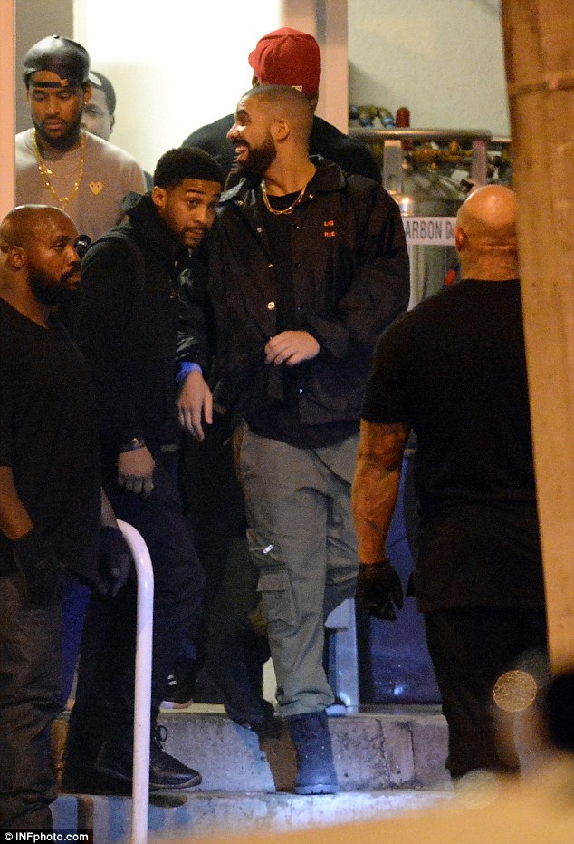 With the boys: Drake rocked a black jacket and gold chain for his party night 