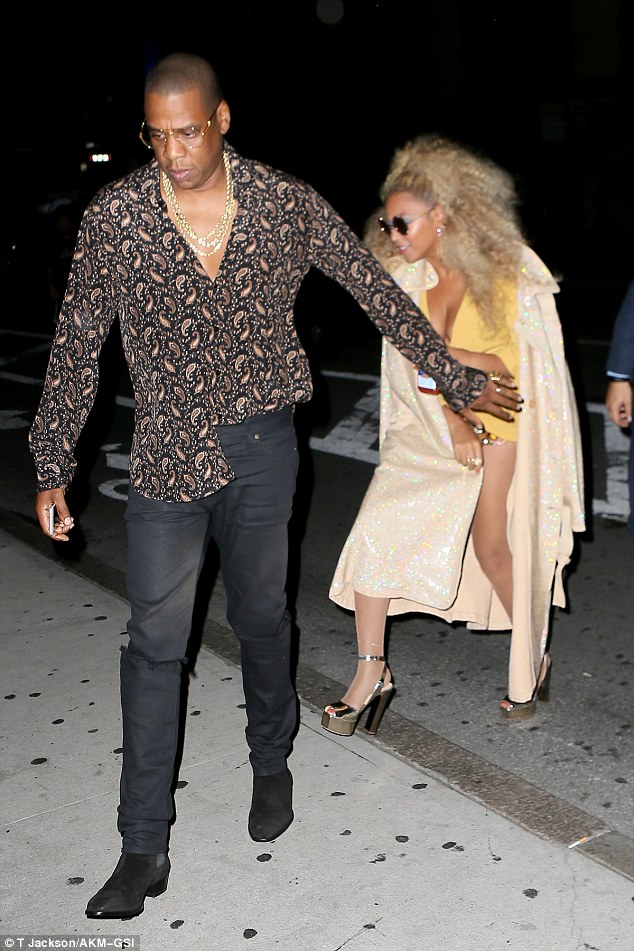 Nothing to see here! Jay-Z helped keep his wife's outfit a surprise as he strode past in a funky ensemble of his own which consisted of a paisley print shirt and thick gold chains 