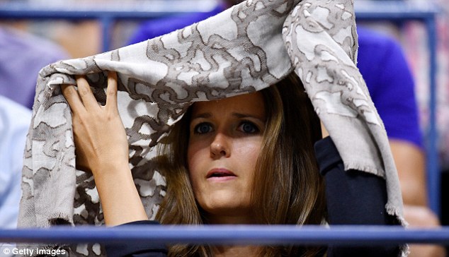 The beige scarf acted as the perfect shelter as Kim cheered on Andy Murray during his match against Grigor Dimitrov of Bulgaria 