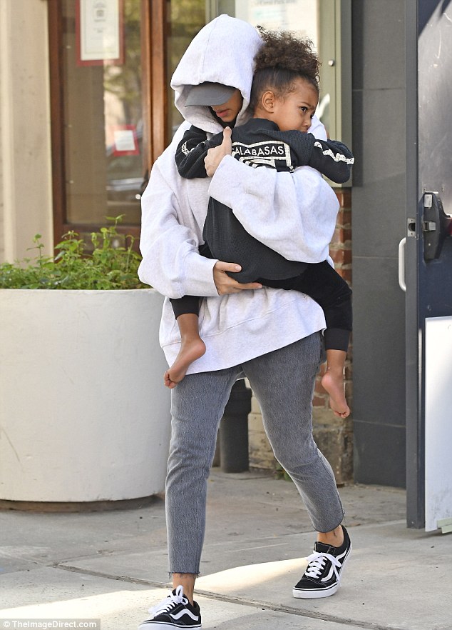 On the move: Kim left her NYC apartment on Thursday carrying her three-year-old daughter North after being holed up at the premises since Monday