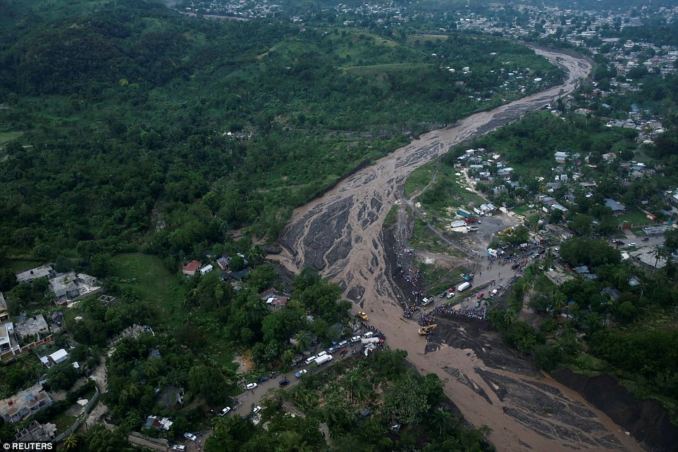 No way across: People gather next to a collapsed bridge after Hurricane Matthew passed Petit Goave, Haiti