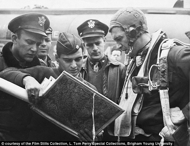 Before entering the military, Stewart earned his commercial pilot license so that he could join the Air Force. Pictured above, a base intelligence officer shows Captain Stewart (right) maps before he begins a mission in WWII