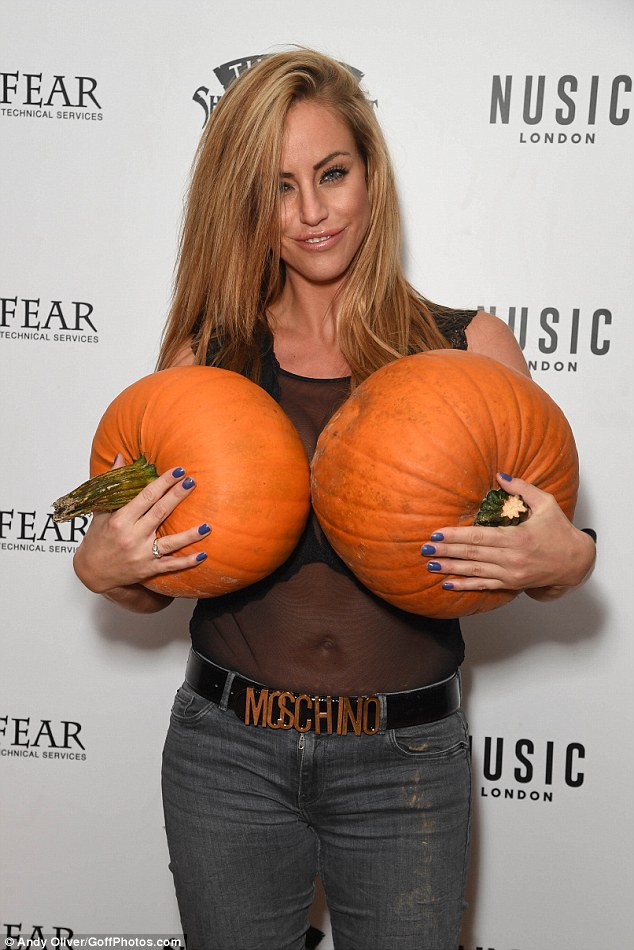 Nice pumpkins! She clutched two of the large fruits to her chest