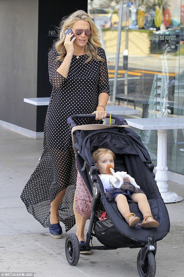 Stylish: Molly was both chic and comfortable in a sheer, polka dot dress that featured a high-slit bottom