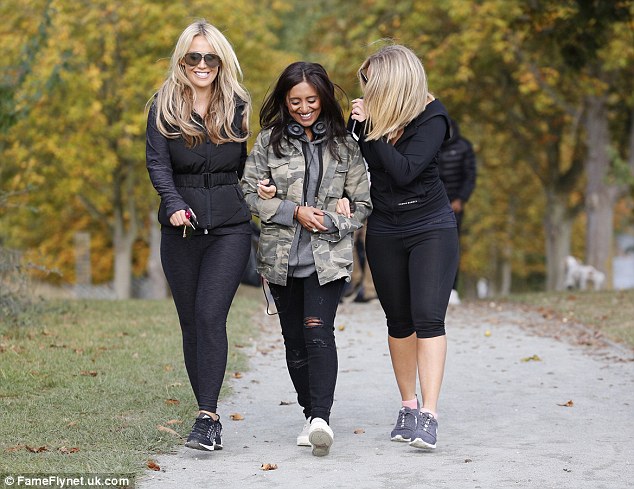 Gal pals: The pair were joined by a friend who had clearly not wanted to join the exercising - clad in ripped jeans and a camouflage jacket