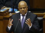 FILE -- In this Feb. 24, 2016, file photo, South African Finance Minister Pravin Gordhan delivers the annual budget speech in parliament in Cape Town, South ...