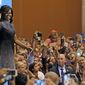 First lady Michelle Obama waves to supporters as she arrives on stage prior to speaking during a campaign rally for Democratic presidential candidate Hillary Clinton Thursday, Oct. 20, 2016, in Phoenix. (AP Photo/Ross D. Franklin)