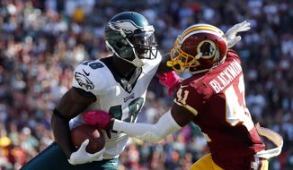 Philadelphia Eagles wide receiver Dorial Green-Beckham, left, tries to avoid Washington Redskins free safety Will Blackmon as he rushes the ball in the second half of an NFL football game, Sunday, Oct. 16, 2016, in Landover, Md. (AP Photo/Alex Brandon)