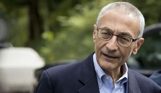 In this photo taken Oct. 5, 2016 file photo, Hillary Clinton&#39;s campaign manager John Podesta speaks to members of the media outside Democratic presidential candidate Hillary Clinton&#39;s home in Washington. Hacked emails reveal internal disagreement among top Clinton aides about her determination to hold a Clinton Foundation summit in Morocco that later drew attention over its reliance on large donations from foreign governments.  (AP Photo/Andrew Harnik, File)