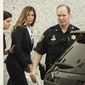 Former Pennsylvania Attorney General Kathleen Kane is escorted from Montgomery County courthouse for her scheduled sentencing hearing in Norristown, Pa, Monday, Oct. 24, 2016. Kane was sentenced Monday to 10 to 23 months in jail for illegally disclosing details from a grand jury investigation to embarrass a rival and lying about it under oath. (AP Photo/Matt Rourke)