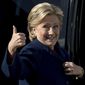 Democratic presidential candidate Hillary Clinton gives a thumbs up to a member of the media as she arrives to board her campaign plane at Westchester County Airport in White Plains, N.Y., Tuesday, Oct. 25, 2016, to travel to Ft. Lauderdale, Fla. for a rally. (AP Photo/Andrew Harnik)