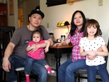 FILE - In this March 19, 2015, file photo, Korean adoptee Adam Crapser, left, poses with daughters, Christal, 1, Christina, 5, and his wife, Anh Nguyen, in the family's living room in Vancouver, Wash. After struggling with joblessness because of his lack of immigration papers, homelessness and crime, Crapser, a South Korean man who was flown to the U.S. 37 years ago and adopted by an American couple at age 3 has been ordered deported back to a country that is completely alien to him, Wednesday, Oct. 26, 2016.  (AP Photo/Gosia Wozniacka, File)