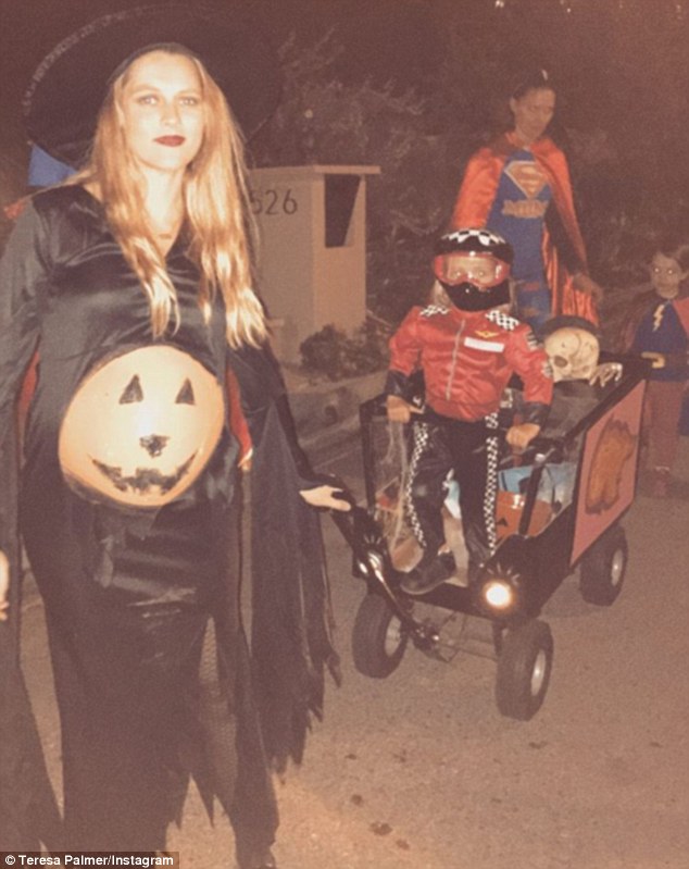 Not slowing down: Despite being 32 weeks pregnant, Teresa Palmer has certainly showed no signs of taking it easy. Pictured in a Halloween costume with two-year-old son Bodhi Rain (centre), whom she shares with Mark Webber