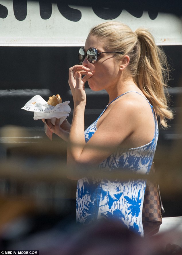 Grabbing a bite: Footy Show host Erin Molan enjoyed a pulled pork sandwich as she strolled through the Double Bay street fair on Saturday