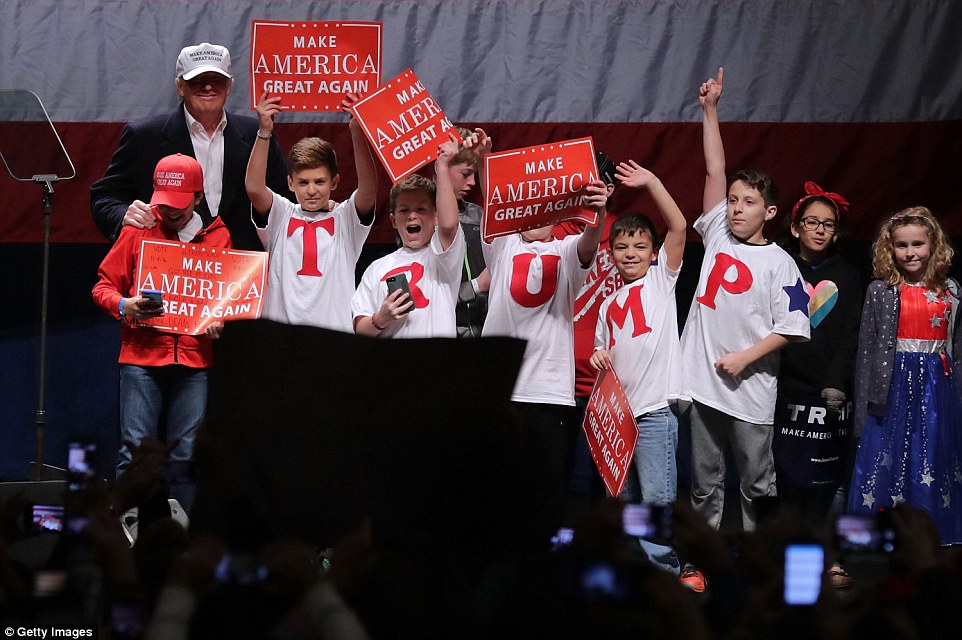 Trump invited a group of children on stage who wore shirts that spelled out his name during the campaign rally in Sterling Heights, Michigan