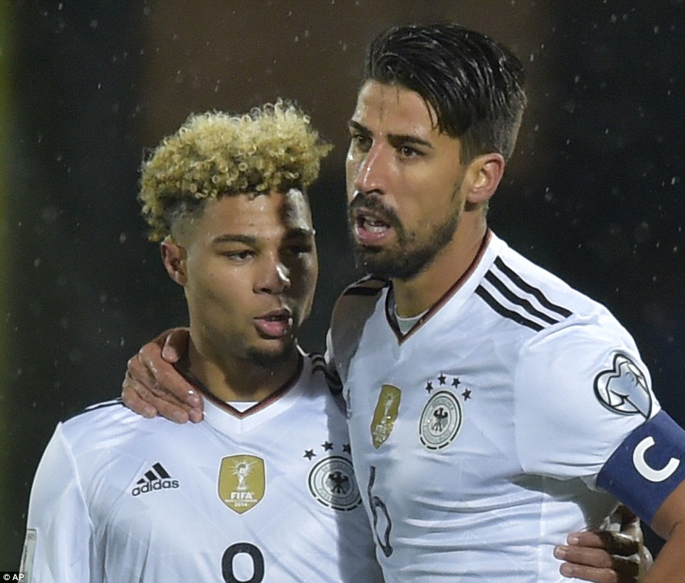 Gnabry celebrates his second goal of the evening with team-mate Khedira at the Serravalle stadium in San Marino