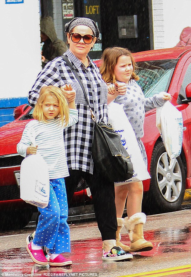 Her favorite role: On Sunday, Melissa McCarthy was spotted dashing through the rain in Los Angeles with her daughters Georgette, six, and Vivian, nine