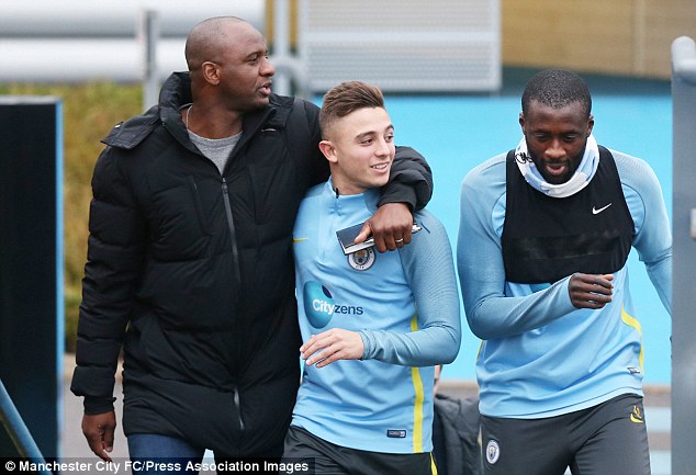 Vieira (left) puts his arm around Pablo Maffeo as he chats to Yaya Toure in Manchester
