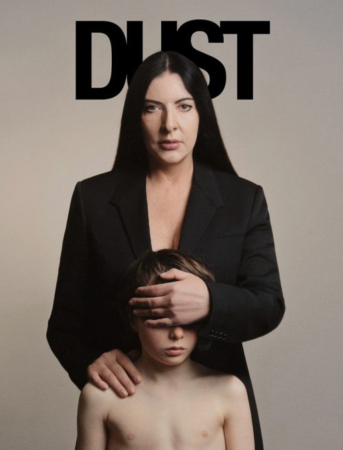 Abramovic on the cover of dust magazine covering the eyes of a shirtless child. 