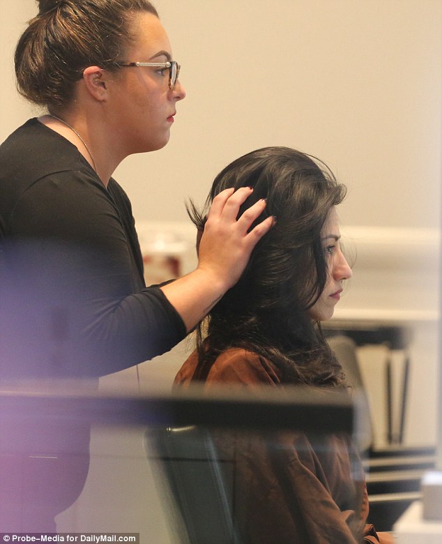 Voila! The hairstylist puts the finishing touches on Huma's do