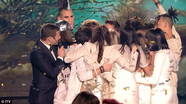 Group hug! Host Dermot O'Leary, left, looked on as the contestants swarmed Matt 