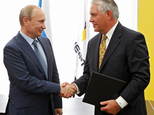 FILE- In this June 15, 2012, file photo, Russian President Vladimir Putin, left, and ExxonMobil CEO Rex Tillerson shake hands at a signing ceremony of an agr...