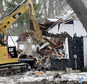 Crew demolish a small house that once belonged to Danny Heinrich, Jacob Wetterling's killer, Friday, Dec. 23, 2016, in Annandale, Minn. Real estate developer Tim Thorne bought the former home of Danny Heinrich specifically to destroy it. The empty house was a distressing reminder to the central Minnesota community that the man who killed 11-year-old Jacob in 1989 had lived among them. (Elizabeth Flores/Star Tribune via AP)
