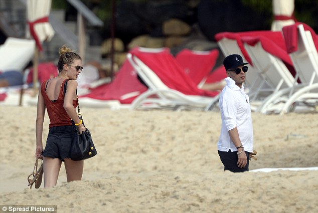 Keeping it simple: Megan arrived at the beach in a burnt orange vest top and hotpants