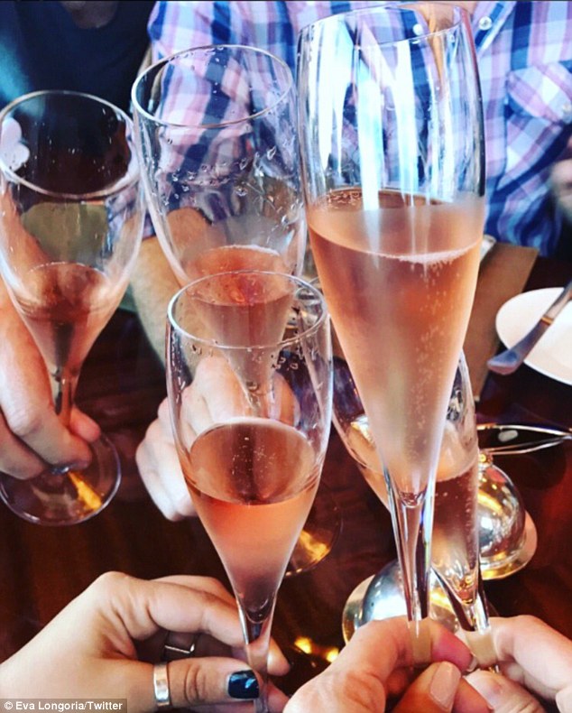 Cheers: Eva Longoria tweeted this photo of pink champagne in longstem glasses
