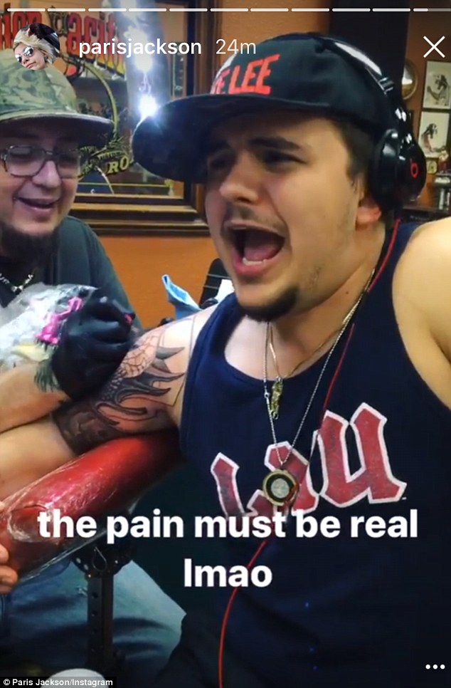 Tough cookie: The tattoo wasn't all fun and games for the celeb offspring. In some shots, the son of MJ was seen wincing in pain
