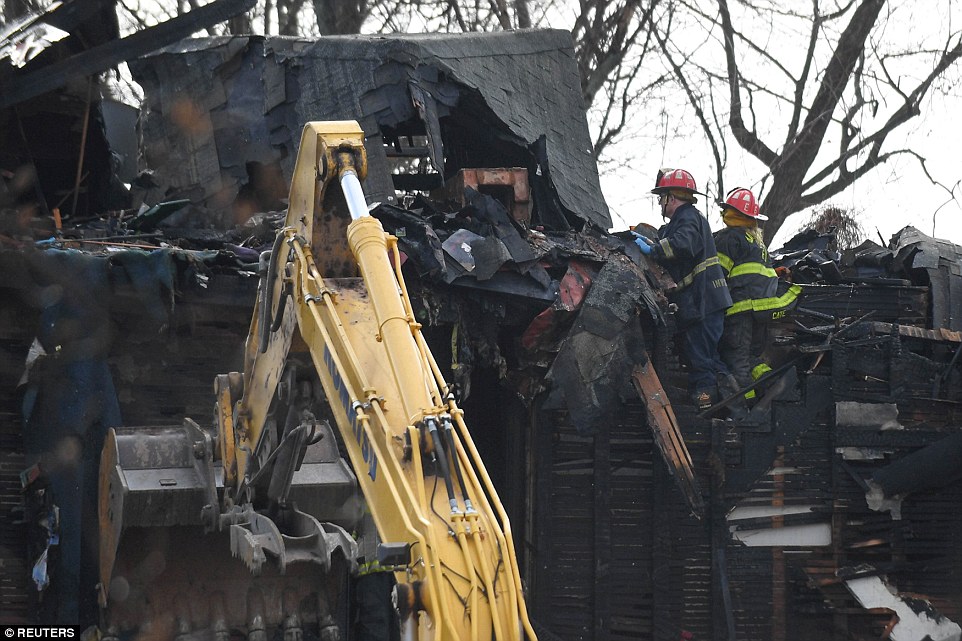 'It's going to be a very, very slow process,' a Baltimore Fire Department spokesperson said. 'We're trying not to disturb any of the remains. So it's going to be what we call a hand dig.' Fire crews are seen above sifting through the burnt wreckage