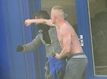 Topless yob in jogging bottoms clashes with anorak-sporting foe as the street fight bursts from the pavement to the road 