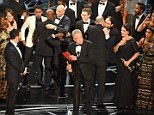 The cast of "Moonlight" and ""La La Land" appear on stage as presenter Warren Beatty (C), flanked by host Jimmy Kimmel (L) shows the winner's envelope for Best Movie "Moonlight" on stage at the 89th Oscars on February 26, 2017 in Hollywood, California. / AFP PHOTO / Mark RALSTONMARK RALSTON/AFP/Getty Images
