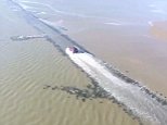 Shocking aerial footage has captured a 'crazy' driver risking his life by racing over a submerged crossing