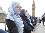 Muslim women stood hand-in-hand with others on Westminster Bridge in a show of solidarity with the victims of Wednesday's terror attack