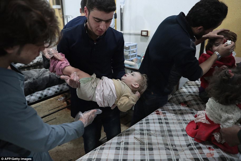 The intensive raids followed an offensive begun by the Syrian army and its allies since late February to encircle the rebel-held Barza neighborhood of the capital and cut it off from nearby Qaboun. Pictured above, Syrian children receive treatment at a makeshift clinic following reported air strikes