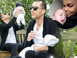 Daddy duties: Wissam Al Mana, 42, was spotted taking their baby boy Eissa for a stroll around a London park in Belgravia on Saturday