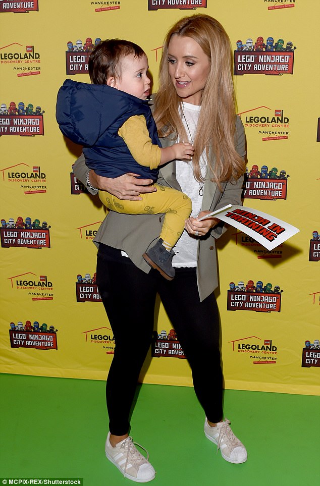 Super cute: Corrie star Catherine Tyldesley lovingly cuddled her young son Alfie at the LEGOLAND discovery launch on Thursday. She gave birth to her son in March last year
