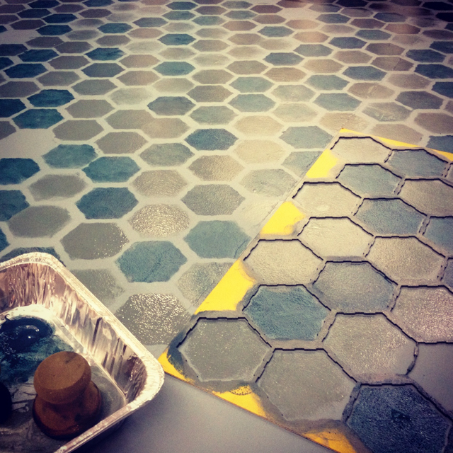 Stenciling a faux tile floor with multiple metallic teals.