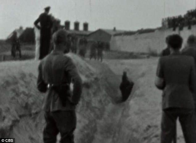 Above, the victims stand as they wait to be shot in a ditch, that was then quickly buried 