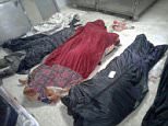 ISIS savages have executed and then dismembered dozens of women and children amid fears the terror group is plotting a wave of massacres in Shiite villages. Body bags were laid out on the floor after an ISIS raid in Aqareb (pictured)